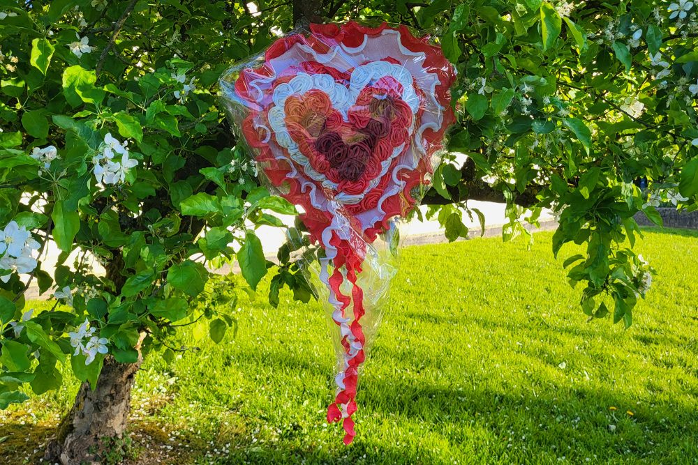 Ein Maiherz hängt an einem Baum