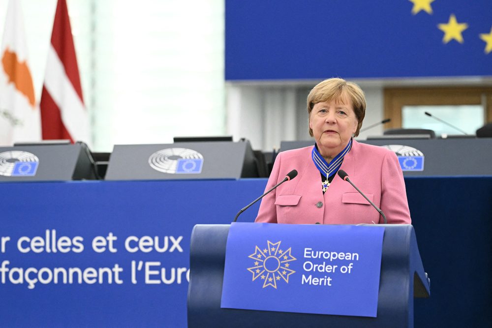 Angela Merkel hält eine Rede im Europaparlament, um den Hals hängt der Europäische Verdienstorden