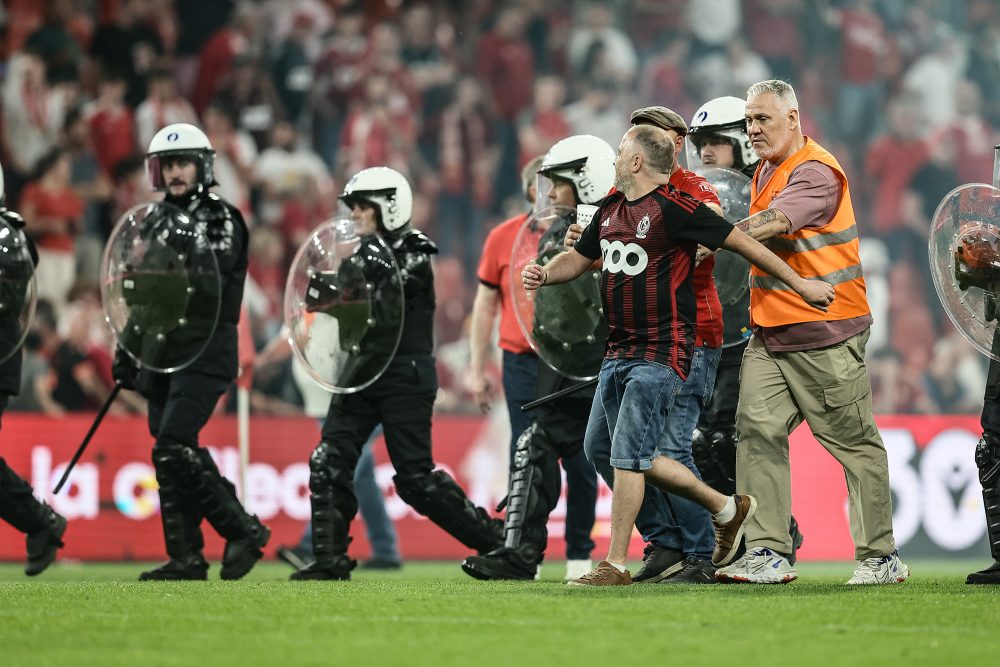 Polizisten treiben Fans vom Platz in Sclessin