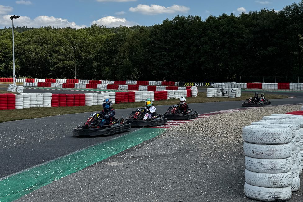 Drei Kart-Fahrer sind dicht an dicht auf der Rennstrecke in Spa, ein vierter ist ein Stück weiter dahinter