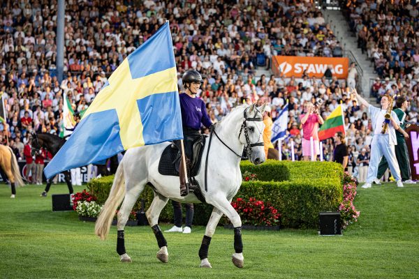 Eröffnungsfeier der Reit-WM 2026 in Aachen: Reiterin mit schwedischer Flagge reitet auf Pferd in die Arena