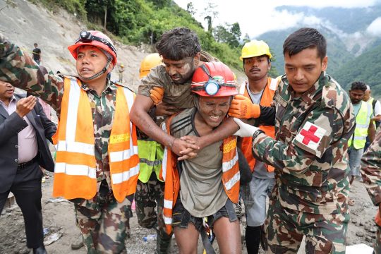 Soldaten tragen einen Arbeiter, während einer Rettungsaktion am Wasserkraftprojekt Trishuli-3A im nepalesischen Distrikt Rasuwa.